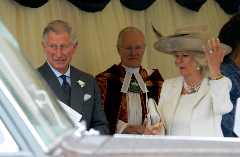 113204s05a 
 113204 - Duke of Edinburgh's 90th Birthday Service at St. Georges Chapel, Windsor - Mike Swift 12/6/2011
The Prince of Wales with The Duchess of Cornwall who does not seem happy with the rain !